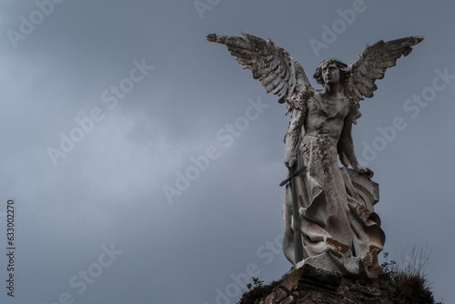 Ancient victorian statue of Destroyer Angel at a graveyard with dark sky. Statue of Abbadon from Josep Limona 1895 photo