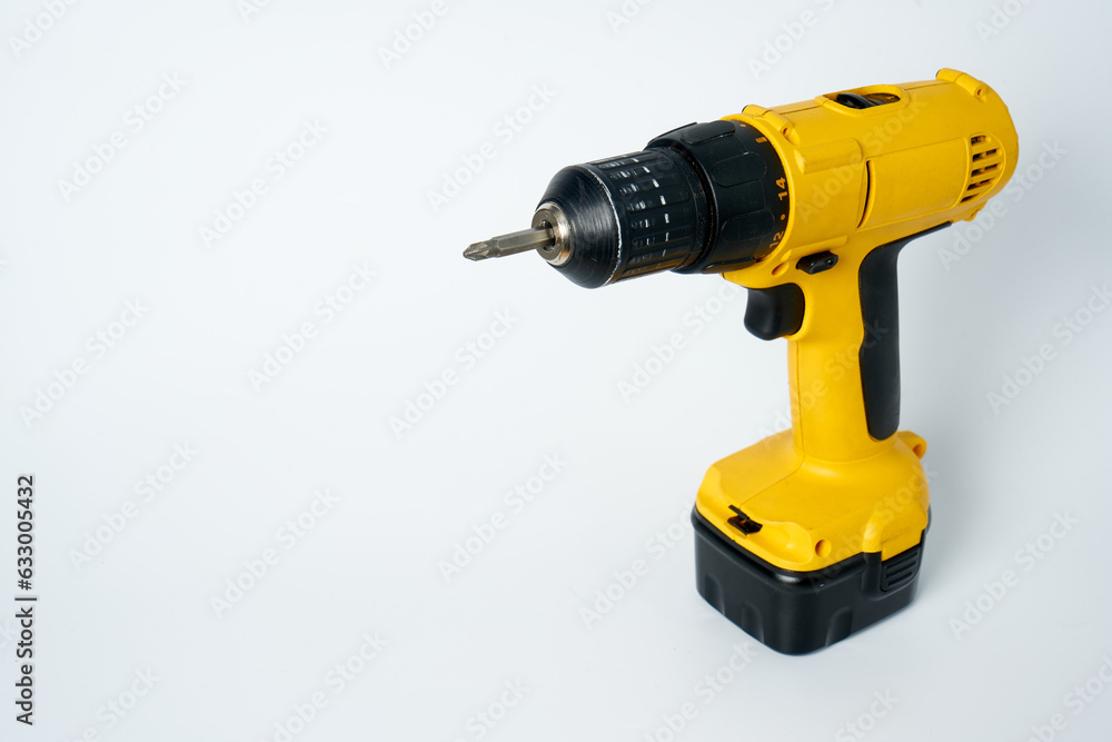 Black and yellow cordless drill on a white isolated background. Black and yellow cordless drill on a white isolated background.