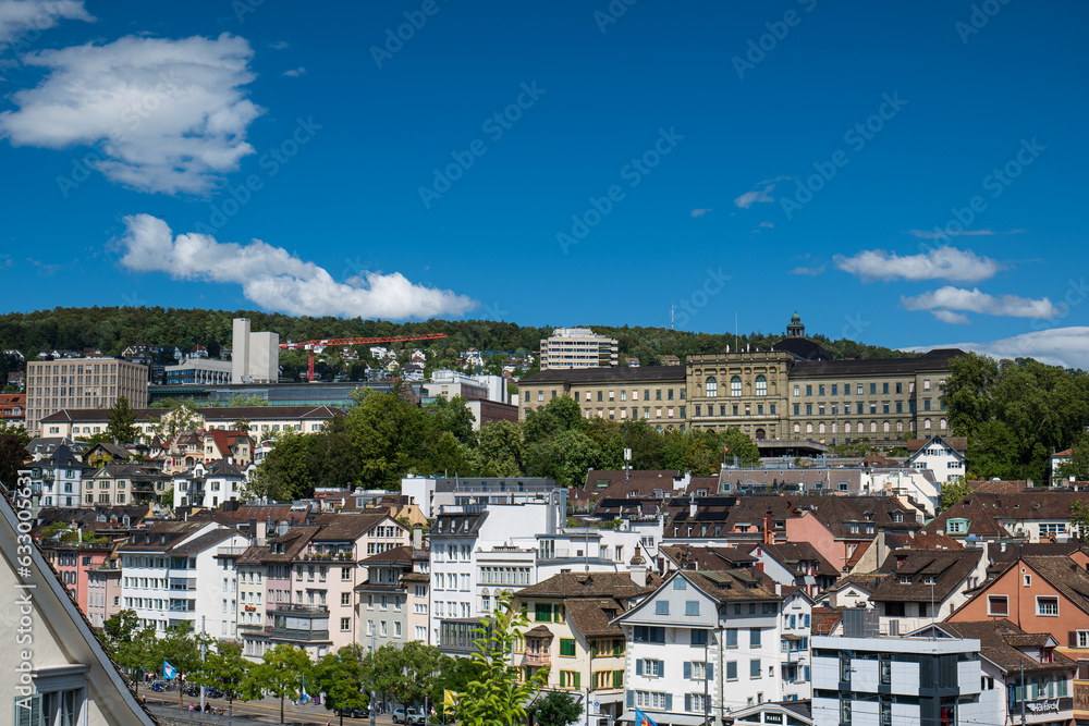 Picturesque view of Zurich city Switzerland. Hillside, old town, sunny summer day, blue sky, ETH university in the background