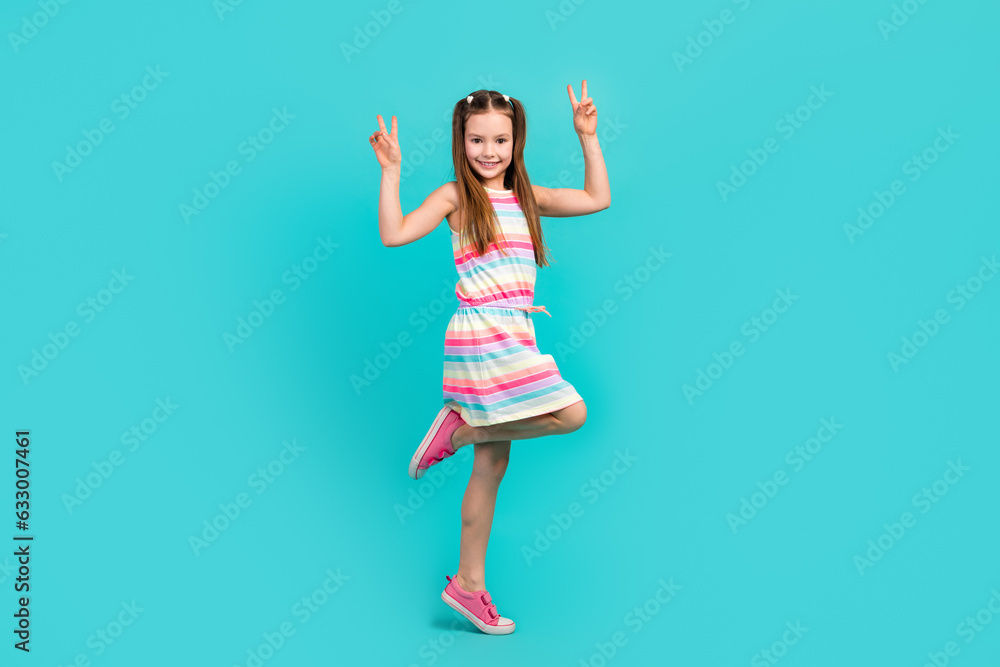 Full length photo of cheerful playful glad wear trendy outfit have fun dance showing v-sign isolated blue color background