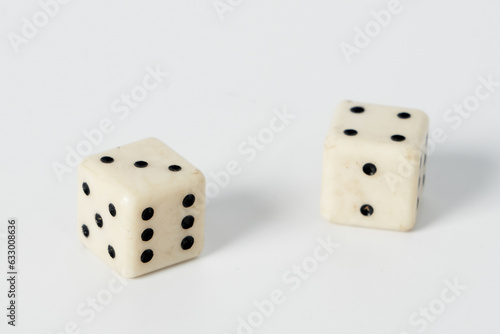 Two white dice on a white isolated background photo