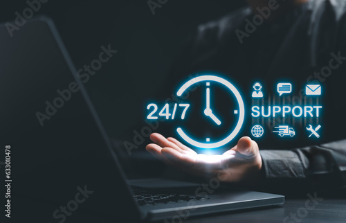 Businessman holding virtual 24 support service icons. Guarantee 24 hour and 7 days per week full-time available contact. Worldwide assistance customer service concept. Call Center for buyer care 24hr.