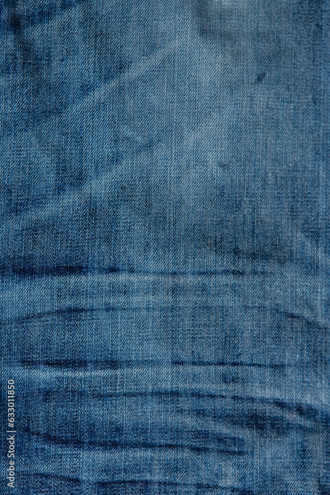 blue denim background with a seam. light blue color denim jeans fabric texture. copy space for text blue denim background with a seam. light blue color denim jeans fabric texture. copy space for text