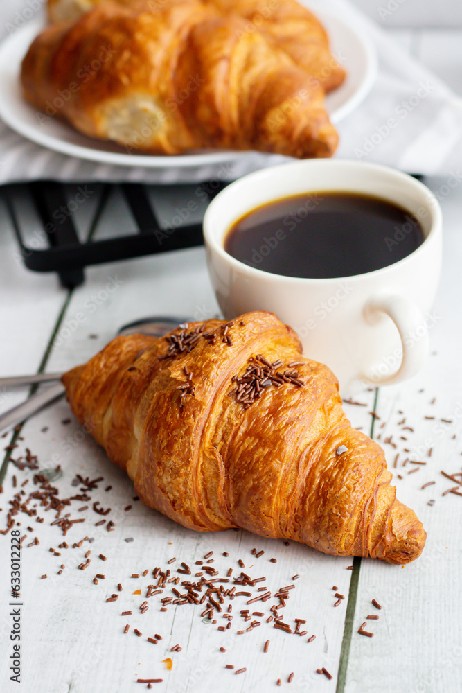 A cup of coffee and croissants. on white wooden. breakfast. Morning A cup of coffee and croissants. on white wooden. breakfast. Morning