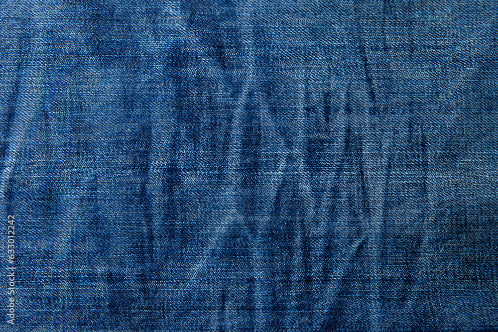 blue denim background with a seam. light blue color denim jeans fabric texture. copy space for text blue denim background with a seam. light blue color denim jeans fabric texture. copy space for text