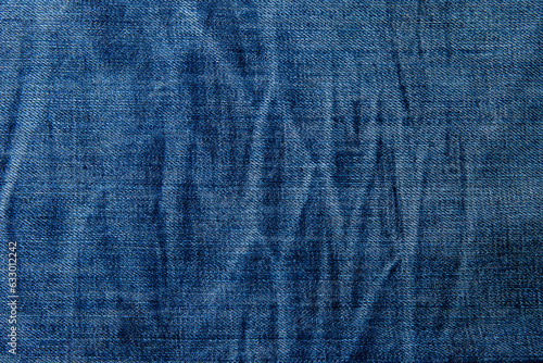 blue denim background with a seam. light blue color denim jeans fabric texture. copy space for text