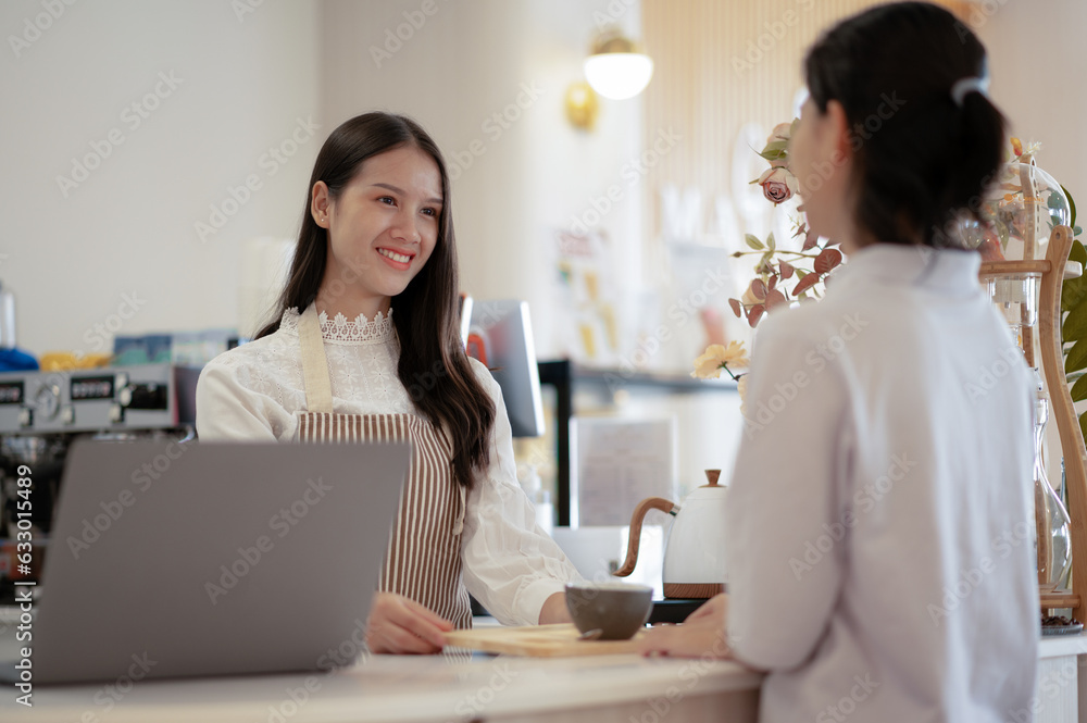 Young women and young men taking orders at the counter in a restaurant. Young women and young men taking orders at the counter in a restaurant.