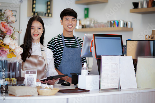 A coffee shop business owner greets customers with a smiling face.