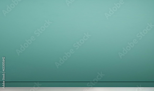 Plain teal wall with a white wooden baseboard, taken from a low angle.