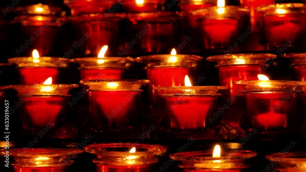 Lots of burning candles in glass candlesticks in the dark. Lots of burning candles in glass candlesticks in the dark.