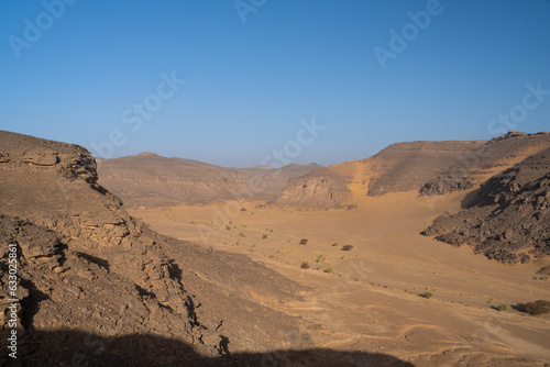 view in the Sahara desert of Tadrart rouge tassili najer in Djanet City ,Algeria.colorful orange sand, rocky mountains