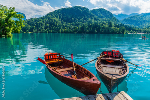 Εκτύπωση καμβά A view past rowing boats moored on a landing stage on Bled island in Bled, Slove