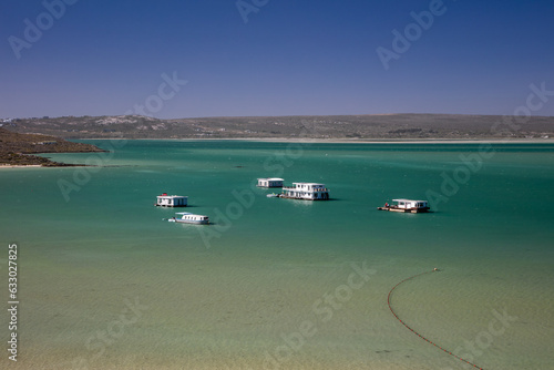 Houseboats on the turquoise water at Kraalbaai in the Langebaan lagoon in the West Coast National Park