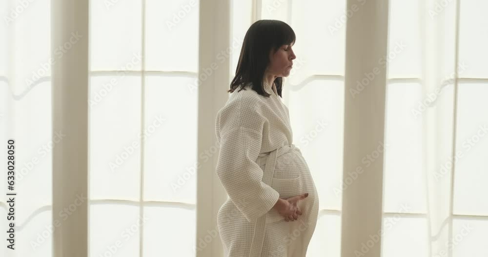 Focused expectant mother is experiencing contractions in the bedroom. Her determined expression reflects her strength and resilience as she navigates through the challenges of labor. Focused expectant mother is experiencing contractions in the bedroom. Her determined expression reflects her strength and resilience as she navigates through the challenges of labor.