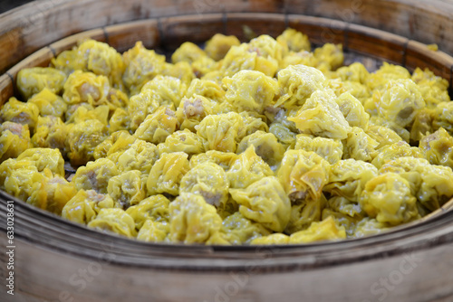 shumai dumpling in bamboo steamer on wooden background