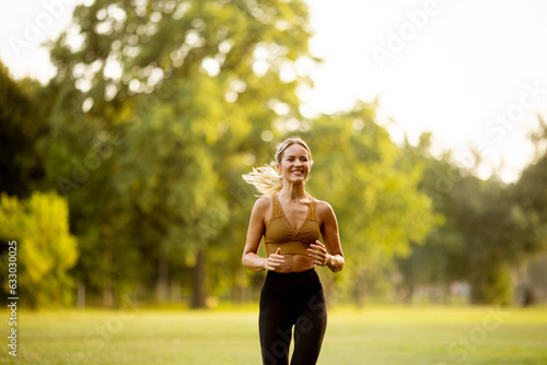 Pretty young woman running in the park