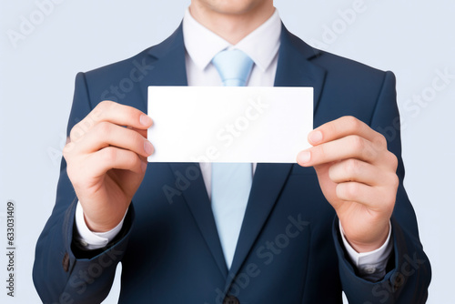 businessman holding blank card