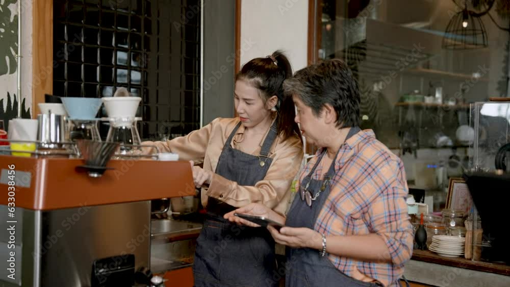 Waitress was waiting for customers orders was senior woman was mother barista owned cafe, they are standing talking telling orders as customers order, have good mood with customers throughout day. Waitress was waiting for customers orders was senior woman was mother barista owned cafe, they are standing talking telling orders as customers order, have good mood with customers throughout day.