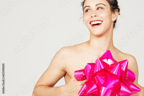 Young woman holding pink gift bow photo