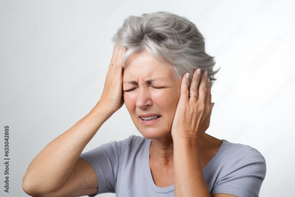 Mature woman suffering from headache on gray background. Health care concept Mature woman suffering from headache on gray background. Health care concept