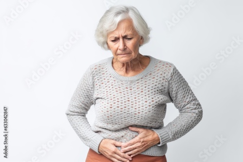Senior woman suffering from stomach ache. Health care and medicine concept.