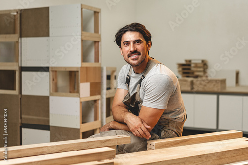 Slika na platnu Portrait of young male carpenter standing in the wood workshop