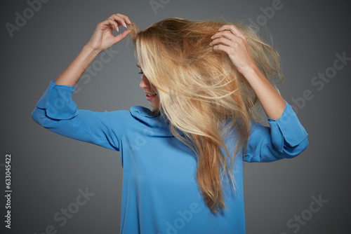 Portrait of young woman tossing her hair. photo