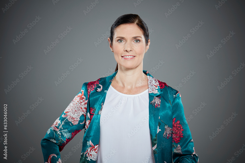 Portrait of mid adult woman wearing floral pattern jacket. Portrait of mid adult woman wearing floral pattern jacket.