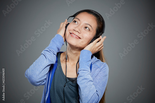 Portrait of mid adult woman listening to music on headphones. photo