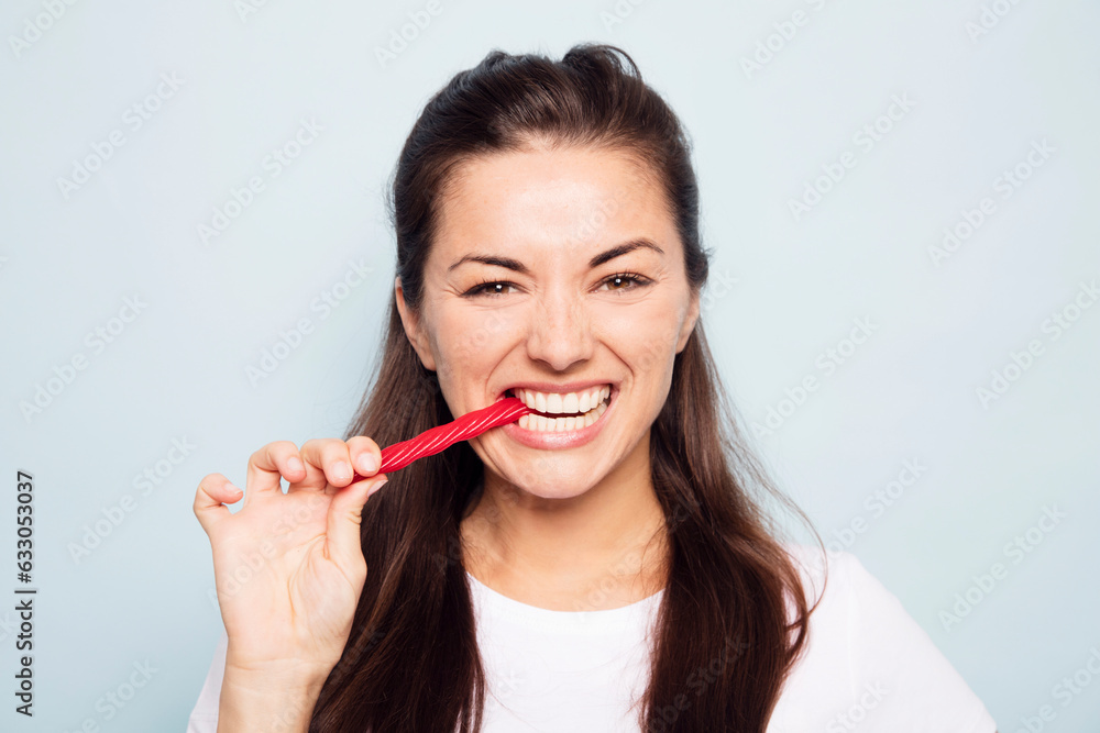 Young woman eating red liquorice Young woman eating red liquorice