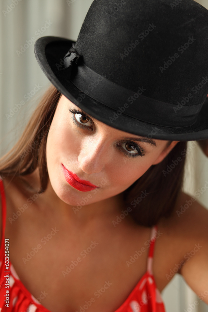Portrait of young woman wearing red lipstick and bowler hat Portrait of young woman wearing red lipstick and bowler hat