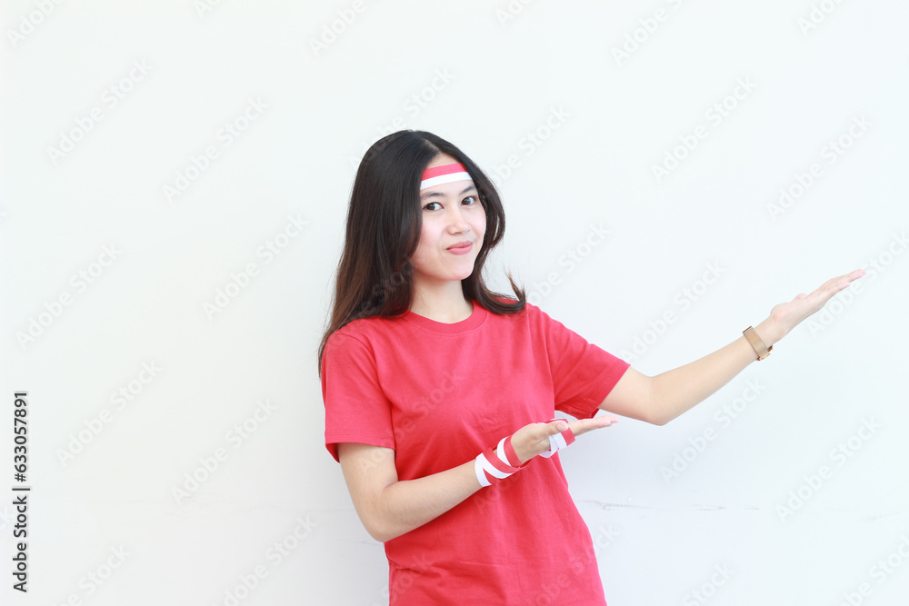 portrait of beautiful asian woman wearing red outfit celebrating Indonesia independence day pointing to the side for copy space portrait of beautiful asian woman wearing red outfit celebrating Indonesia independence day pointing to the side for copy space