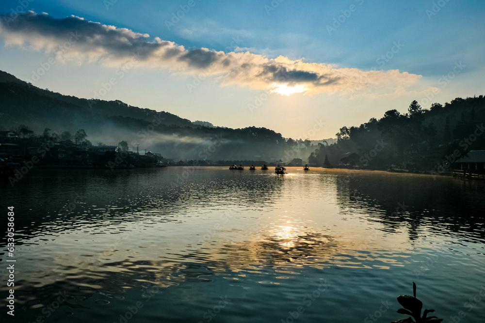 Sunris, Travel to Yunnan Chinese Village by the lake, Baan Rak Thai,Mae Hong Son, see the view of the village surrounded by mountains. There is a reservoir in the middle of the village.In the morning.