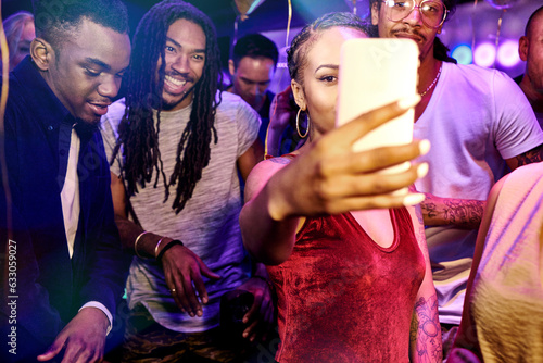 Friends taking selfie at nightclub photo