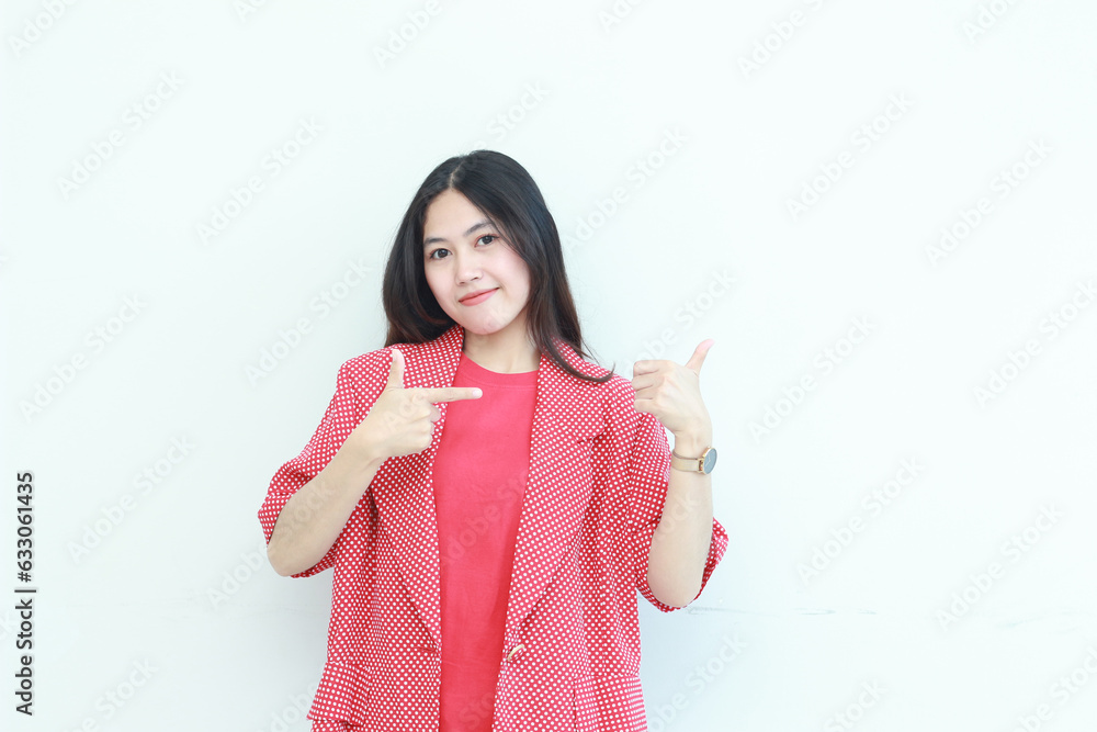 portrait of beautiful asian woman wearing red outfit pointing to the side for copy space with smiling gesture portrait of beautiful asian woman wearing red outfit pointing to the side for copy space with smiling gesture