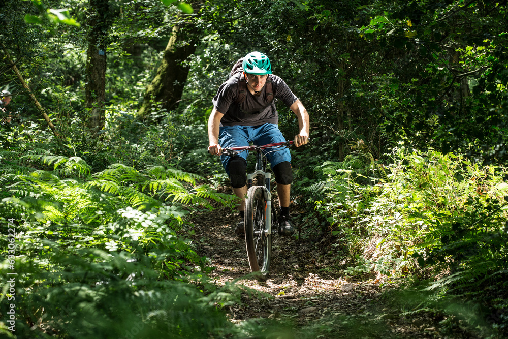 Man mountain biking in forest Man mountain biking in forest