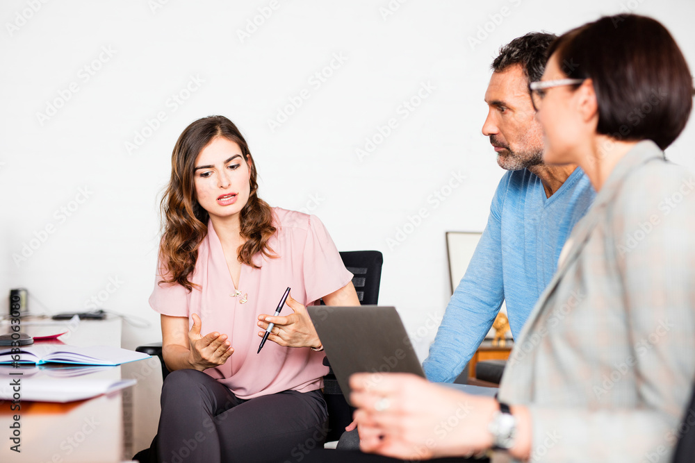 Businesspeople in discussion during meeting in office Businesspeople in discussion during meeting in office