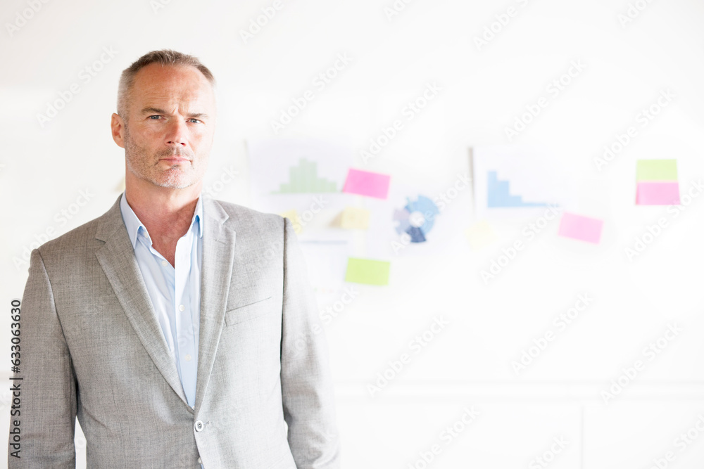 Portrait of businessman by graphs on bulletin board Portrait of businessman by graphs on bulletin board