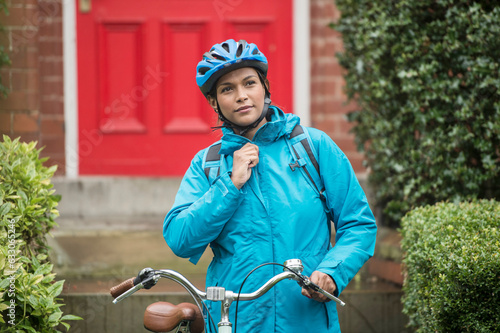 Woman in blue jacket commuting by bicycle photo