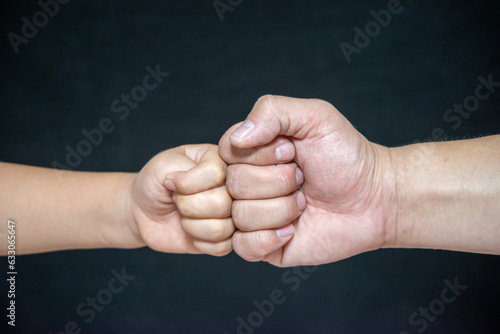 A Fist Of A Child And An Adult Male,Competition And Victory Concept