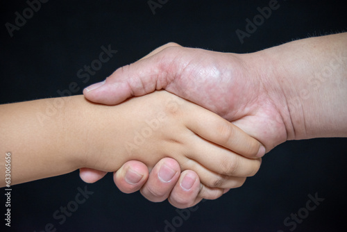 Child and Adult Shaking Hands，Concept of cooperation and success