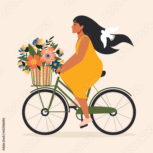 A happy girl, in a yellow dress and a white dove in her hair, rides an urban green bicycle with a bouquet of spring flowers in a basket. 