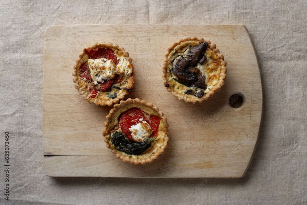 Quiches on chopping board Quiches on chopping board
