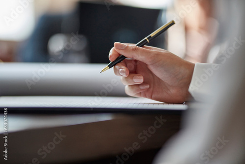 Hand of businesswoman signing document photo