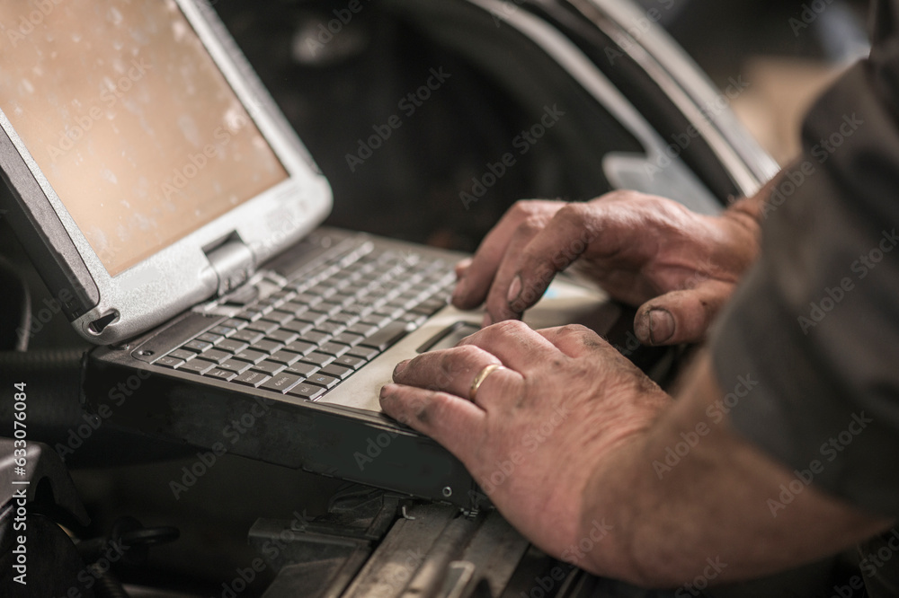 Hands of mechanic using laptop Hands of mechanic using laptop