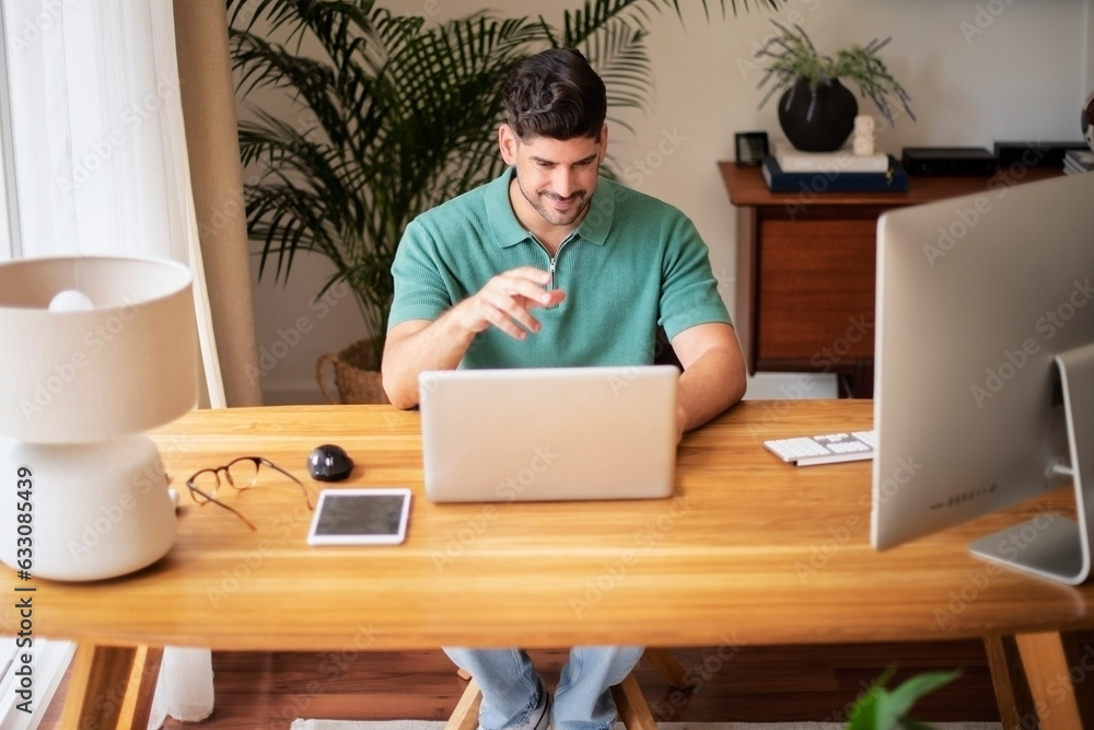 Confident businessman sitting at desk with laptop and working at home Confident businessman sitting at desk with laptop and working at home