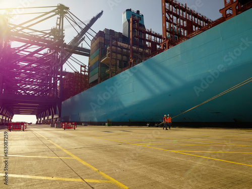 Blue cargo ship and cargo cranes in dockyard, Felixstowe, England.