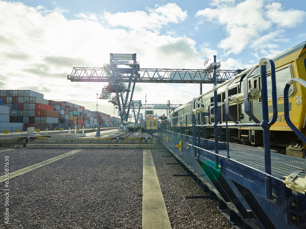 Train at platform in dockyard with cargo cranes, Felixstowe, England. Train at platform in dockyard with cargo cranes, Felixstowe, England.