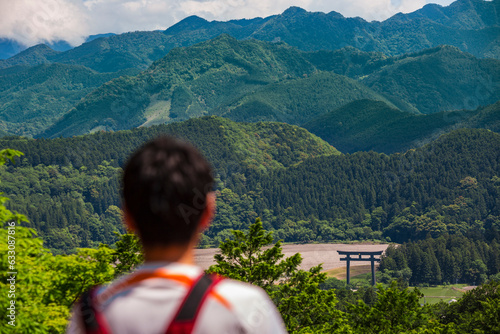 View of man looking on mountains, Kumano Kodo Pilgrimage Route, Japan photo