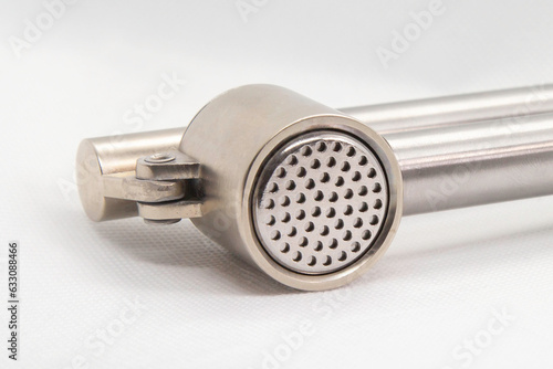 close up of Garlic crusher on white background  photo